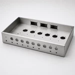 Brushed aluminum guitar amplifier chassis front three-quarter view with precision cutouts and folded edges