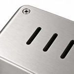 Close-up of linear ventilation slots and a flush-mounted fastener on a stainless steel cleanroom enclosure