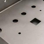 Laser-cut mounting holes and rectangular cutout on welded sheet metal chassis frame