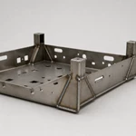 Side view of welded sheet metal equipment chassis frame showing corner joints and support gussets